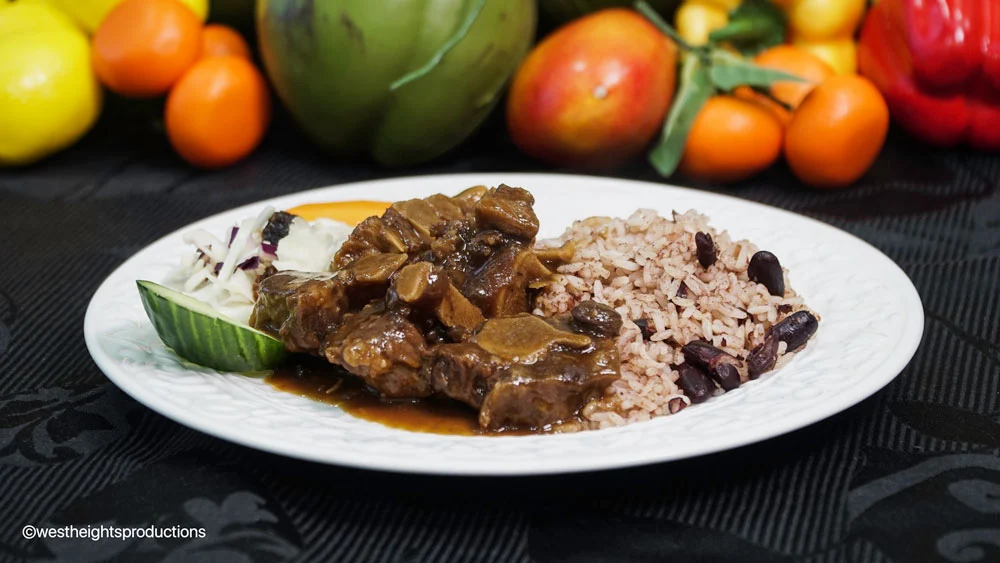 A captivating image showcasing the culinary excellence of Jamaican restaurants in Mississauga, exemplified by the exceptional quality of Jerk and BBQ Haven. The photograph highlights a sumptuous Oxtail Meal, a signature dish beloved by Jamaican food enthusiasts. Located in the Greater Toronto Area (GTA), Jerk and BBQ Haven stands out as a premier destination for authentic Jamaican cuisine.