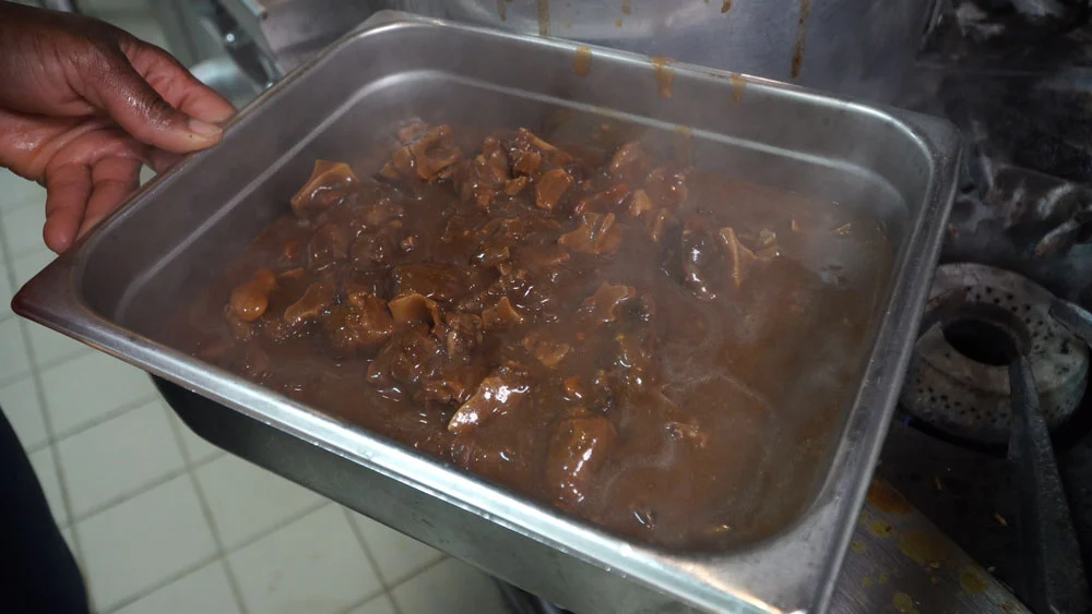 A captivating image showcasing the culinary excellence of Jamaican restaurants in Mississauga, exemplified by the mouthwatering pan of Oxtail. The photograph highlights the quality work and dedication to authenticity at Jerk and BBQ Haven, a prominent establishment serving the Greater Toronto Area (GTA). 